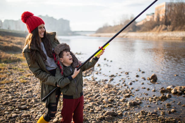 istock A funny boy and his mom fishing 1220638607