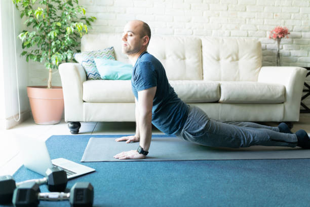 Active man doing yoga at home