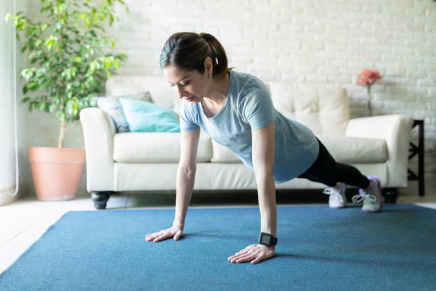 istock Woman in her 40s exercising at home 1220640249