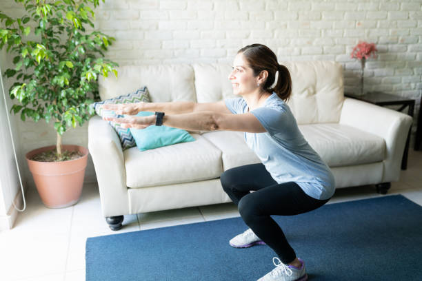istock Pretty woman enjoying her workout at home 1220640266