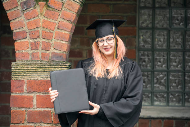 istock Proud Graduate Holding Diploma Outdoors 1220641425