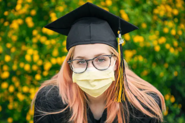 Photo of Graduate in Cap and Pandemic Face Mask