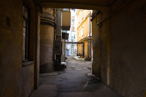 Passage into the courtyard of an old house in the historic quarter of the city of Kiev, Ukraine. Old dilapidated apartment houses