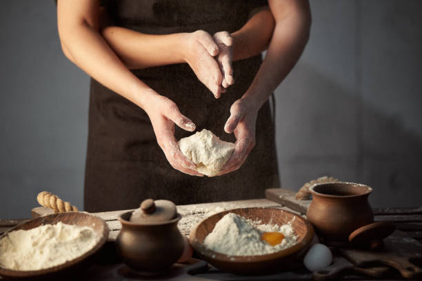 istock Concept woman with many hands speaks from flour dough, on the kitchen table. 1220641999