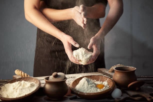 istock Concept woman with many hands speaks from flour dough, on the kitchen table. 1220642005