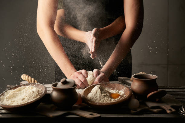 istock Concept woman with many hands speaks from flour dough, on the kitchen table. 1220642009