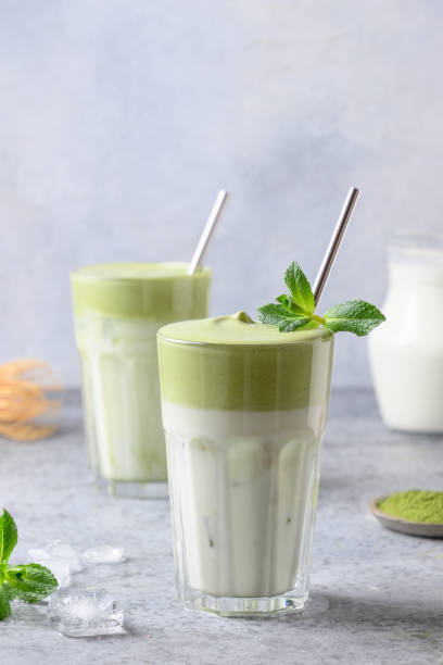 istock Two glasses of Dalgona Matcha latte tea. Close up. Vertical format. 1220644081