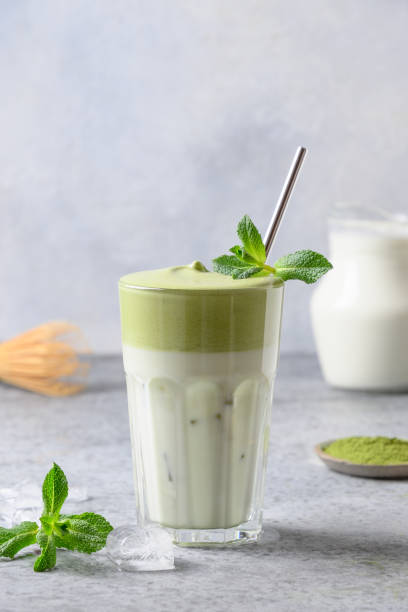 istock Dalgona Matcha latte tea with milk and whipped tea garnish mint. Close up. 1220644288