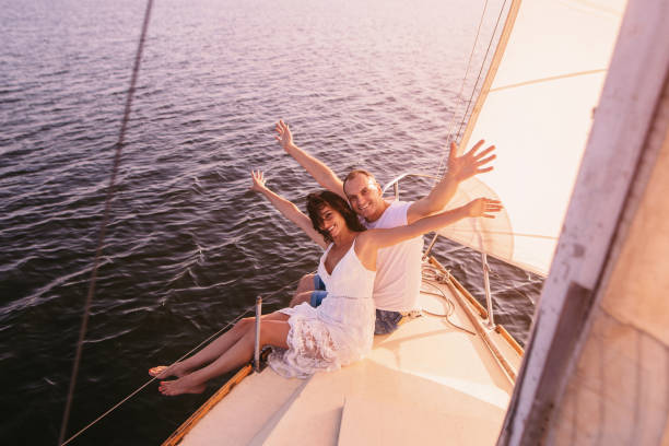 istock Couple stting on sailboat deck with open arms 1220645651