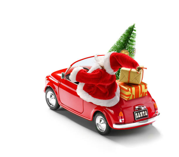 istock Santa Claus driving red car with gift boxes and Christmas tree isolated on white, view from outside 1220645806
