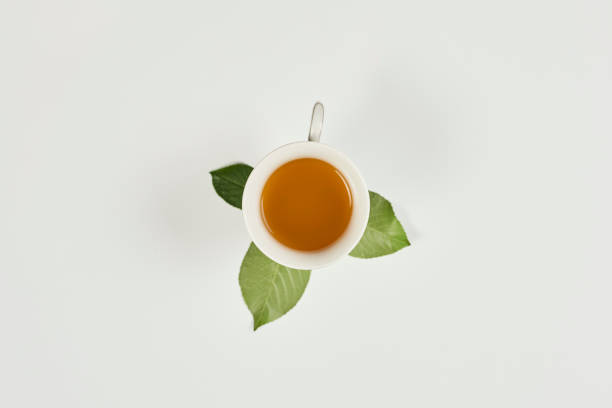 istock A cup of tea and leafs on white 1220647214
