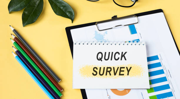 istock Quick Survey text written on a notebook with pencils and graphs. 1220647250