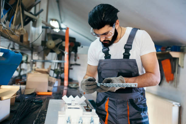 istock Manual worker holding metal plate in workshop 1220648283