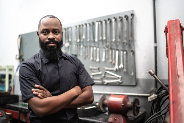 Portrait of mechanic man with crossed arms in auto repair Car mechanics, workers, customers, satisfaction / Auto car repair service center. car portrait men expertise stock pictures, royalty-free photos & images