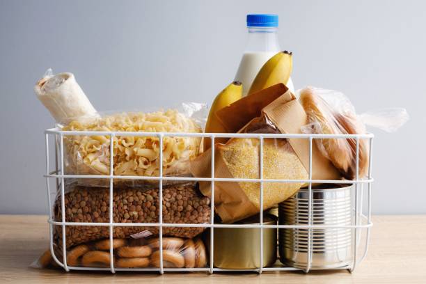 istock Donation box with food on grey background 1220648687