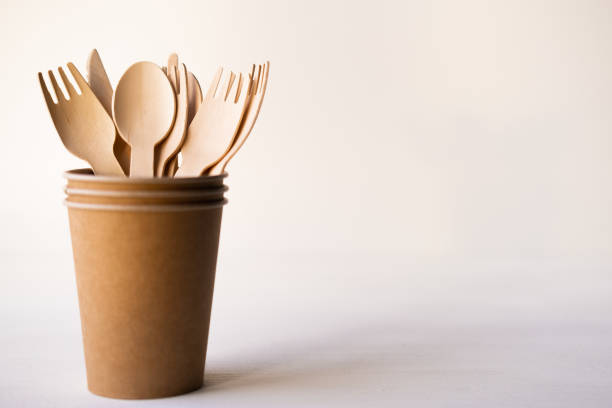 istock eco friendly disposable kitchenware utensils on white background. wooden forks and spoons in paper cup. ecology, zero waste concept. copyspace 1220650740