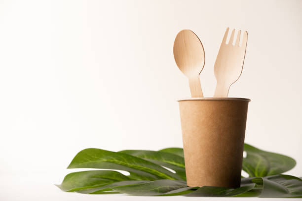 istock eco friendly disposable kitchenware utensils on white background. wooden forks and spoons in paper cup. ecology, zero waste concept. top view. flat lay 1220650924