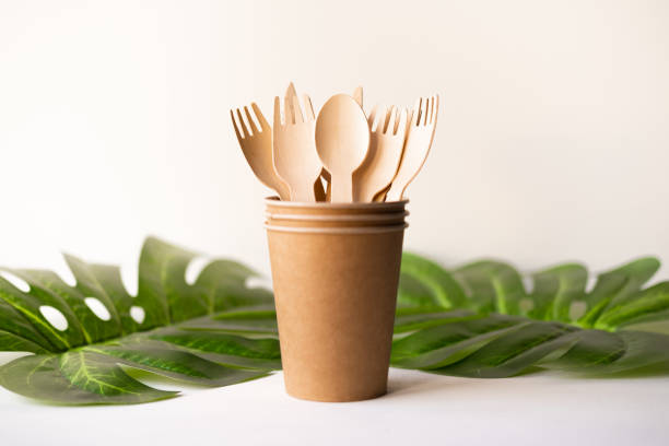 istock eco friendly disposable kitchenware utensils on white background. wooden forks and spoons in paper cup. ecology, zero waste concept. top view. flat lay 1220650950