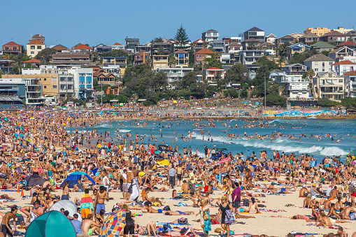 Very crowded but immensely popular Bondi Beach in Sydney. Thousands of sun lovers will gather here to swim and surf on any sunny day, tourists and locals alike.