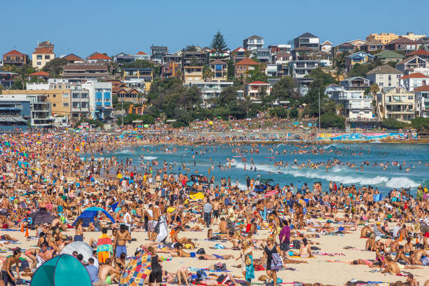 Very crowded but immensely popular Bondi Beach in Sydney Very crowded but immensely popular Bondi Beach in Sydney. Thousands of sun lovers will gather here to swim and surf on any sunny day, tourists and locals alike. bondi beach photos stock pictures, royalty-free photos & images