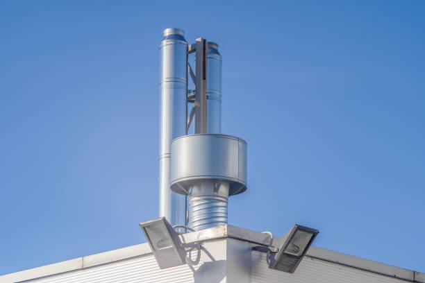 istock shiny metal ventilation pipes blue sky background 1220651898