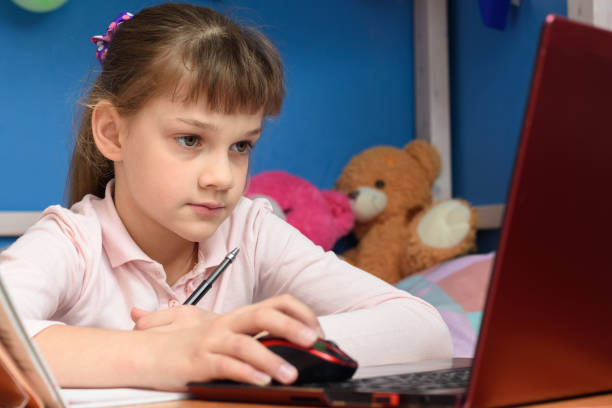 istock The girl is remotely studying at home, working in a laptop 1220653643