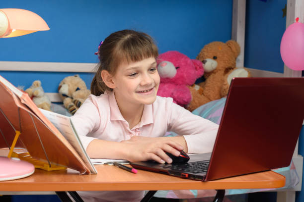 istock Girl joyfully studying at school without leaving home 1220653648