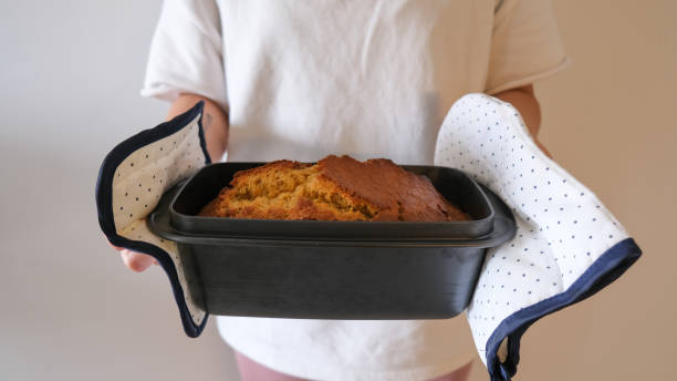 istock Woman Holding a Fresh Baked Cake 1220655336