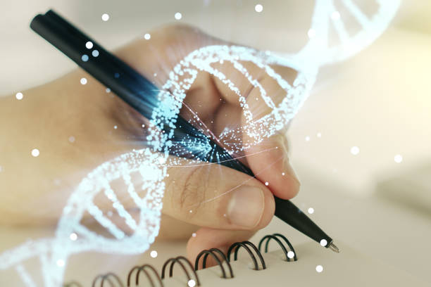 istock Double exposure of creative DNA hologram and man hand writing in notebook on background. Bio Engineering and DNA Research concept 1220656692