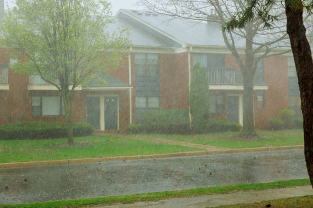 istock Rain water flowing from apartment building during heavy rain 1220659582