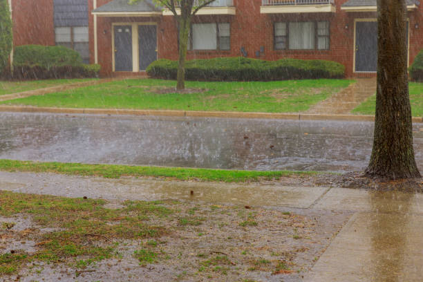 istock Rainy season heavy rainfall apartment building during strong winds heavy rain drops falling on asphalt 1220659587