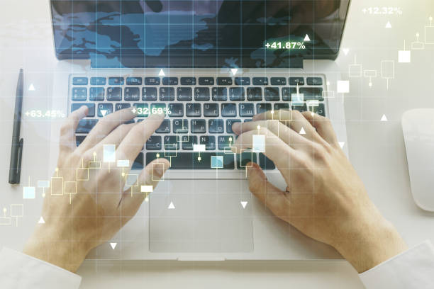 istock Multi exposure of abstract financial graph with world map and with hand typing on laptop on background, financial and trading concept 1220664086
