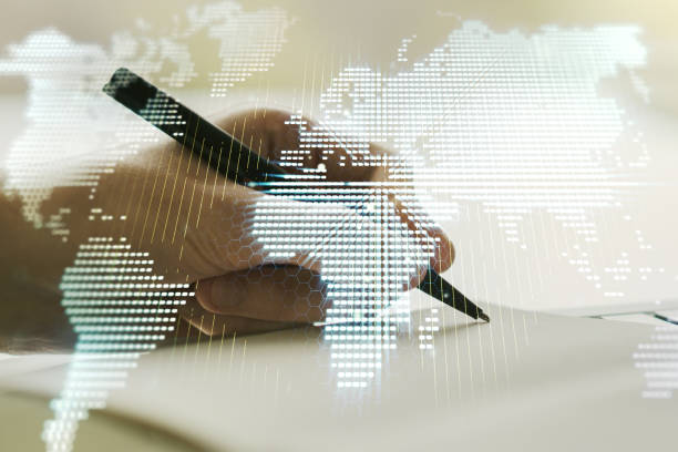 istock Abstract creative digital world map and man hand writing in diary on background, globalization concept. Multiexposure 1220664137