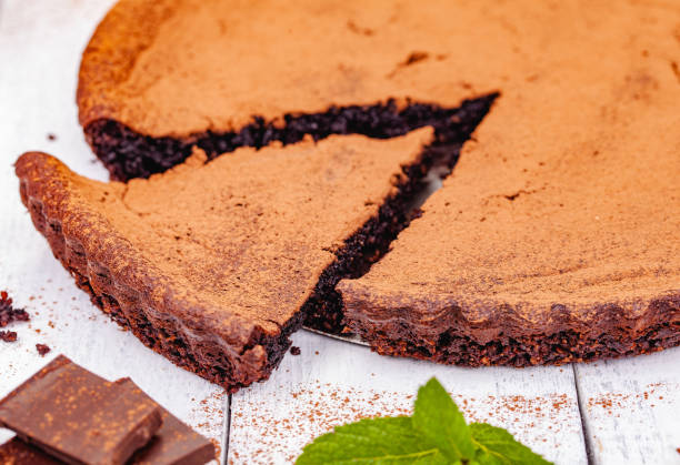 istock Sliced chocolate pie with cinnamon on wooden rustic table. Close up 1220664167