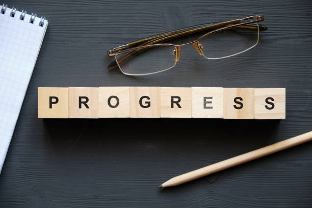 istock Modern business buzzword - progress. Top view on wooden table with blocks. Top view. 1220666107