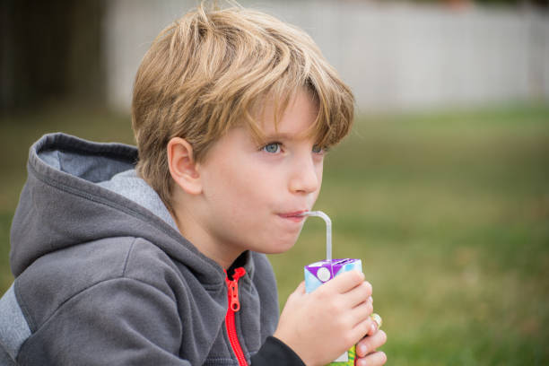 istock Portrait of a kid drinking juice with a straw 1220667173