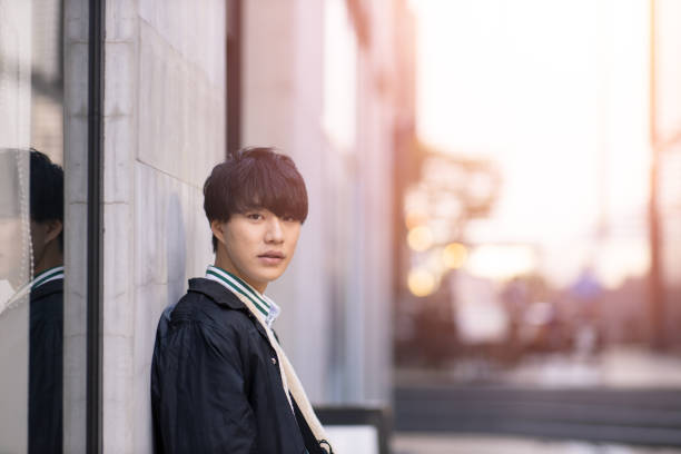 Portrait of young man leaning on wall