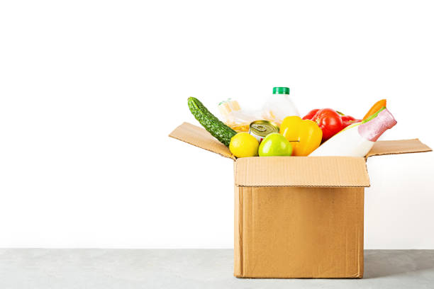 istock Donation box with various smart food on white background with copy space. Mockup. Food donations or food delivery service concept. Online shopping during coronavirus covid-19 lockdown 1220669649