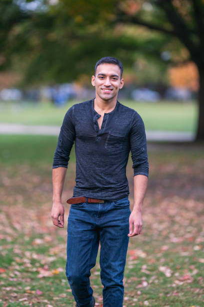 istock Handsome Indian man walking in park 1220669678