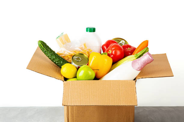 istock Donation box with various smart food on white background with copy space. Mockup. Food donations or food delivery service concept. Online shopping during coronavirus covid-19 lockdown 1220669716
