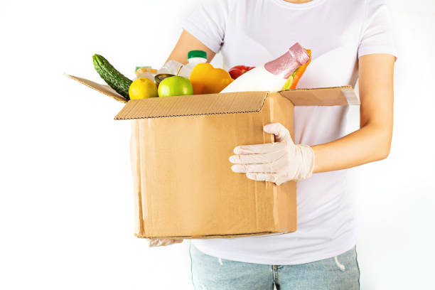 istock Donation box with various smart food on white background with copy space. Mockup. Food donations or food delivery service concept. Online shopping during coronavirus covid-19 lockdown 1220669826