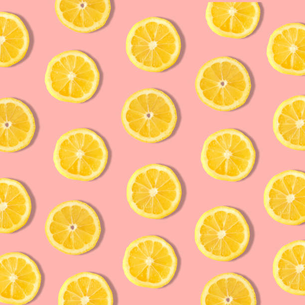 istock Summer fruit pattern of lemon slices on a pastel pink background 1220671066