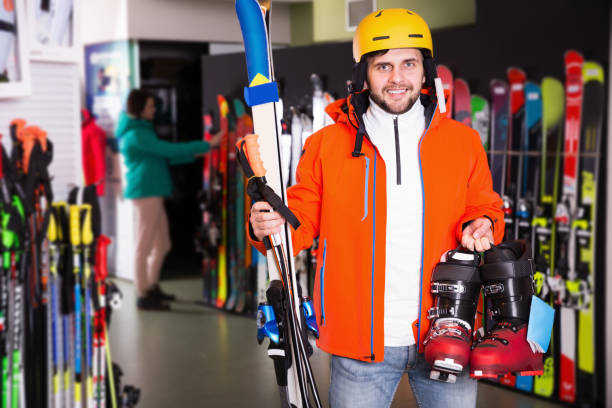 istock Cheerful young man posing in skiing gear during shopping 1220671096
