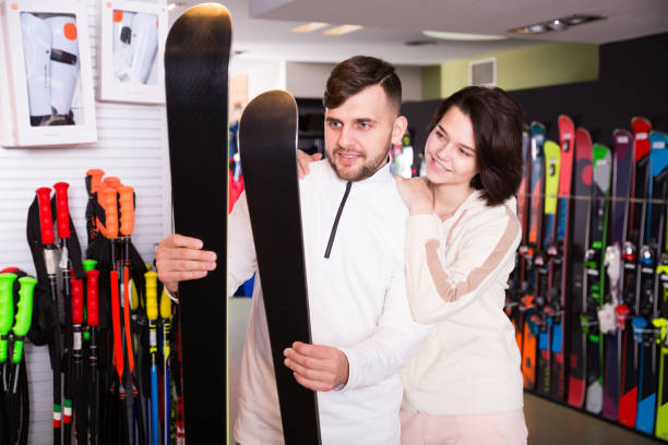 istock couple of  skiers selecting skis 1220671099