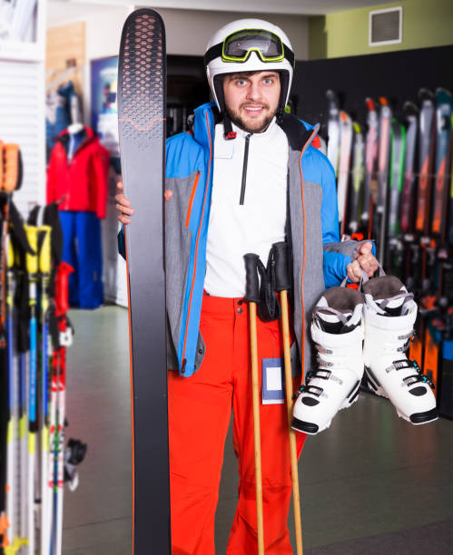istock Guy in skiing outfit in shop 1220671105