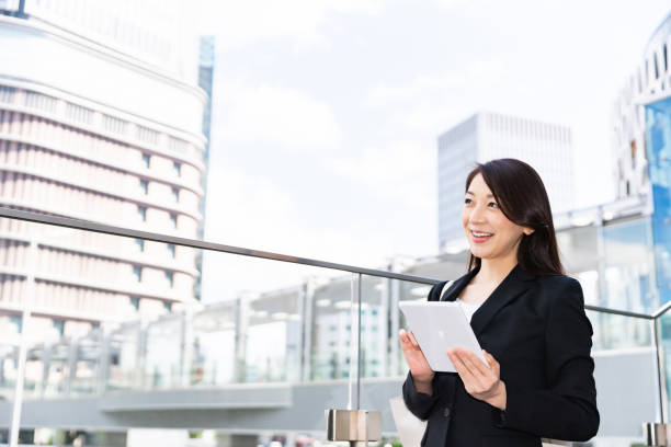istock asian woman who see a tablet computer 1220679201