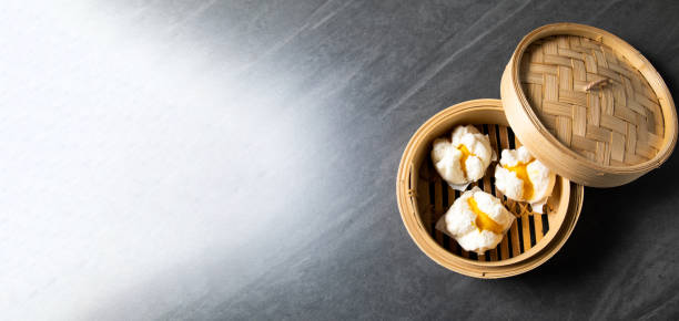 Chinese Traditional cuisine concept. Dumplings Dim Sum in bamboo steamer with text copy space. Asian food background