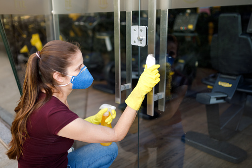Woman disinfecting with alcohol