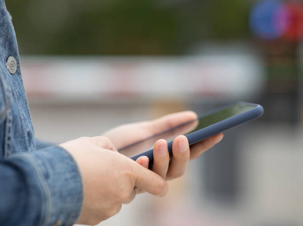 istock Asian woman using smartphone at city 1220687045