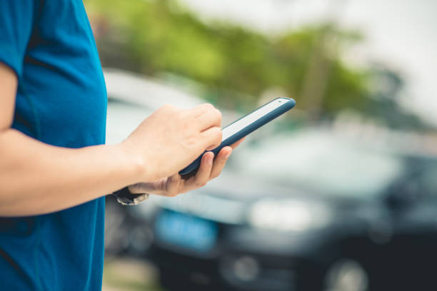 istock Asian woman using smartphone outdoors 1220689636